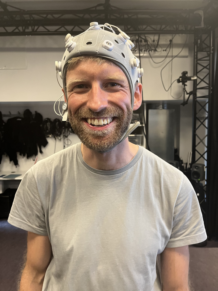 Photograph of a workshop co-participant wearing an EEG cap.