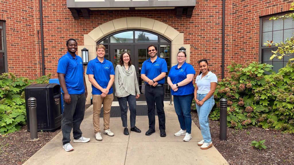 Photograph of Sofia standing with members of the Saint Louis University CHROME Lab